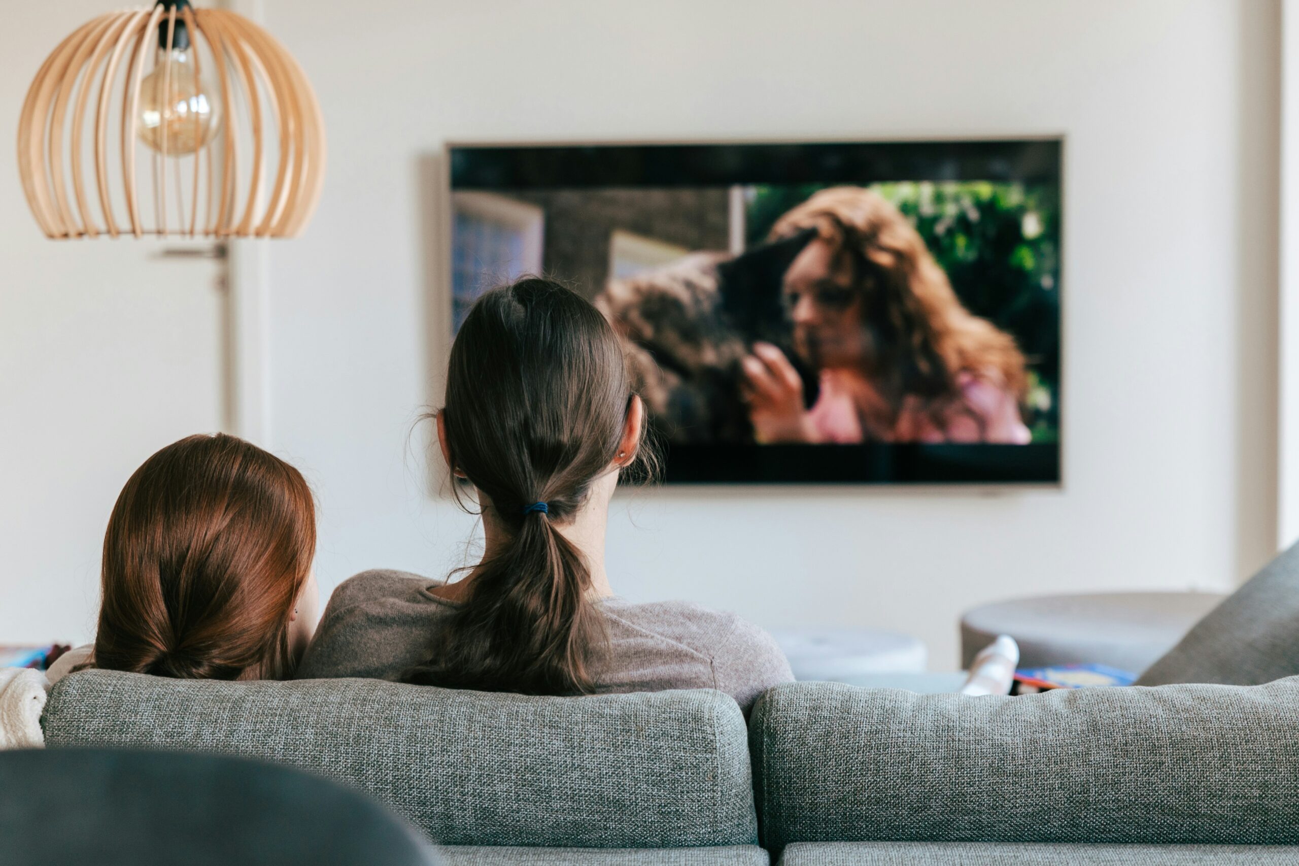 TV Streaming with two people sitting on a couch watching the screen.